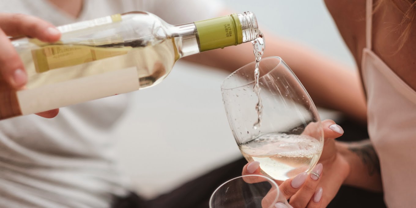 A man pouring Champaigne in a Woman glass