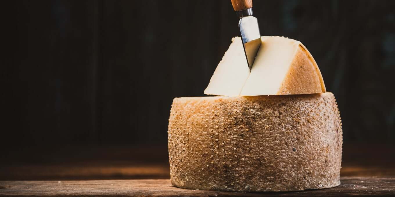 Hard cheese with a small cheese knife. Serve cheese and wine as a starter is always good!