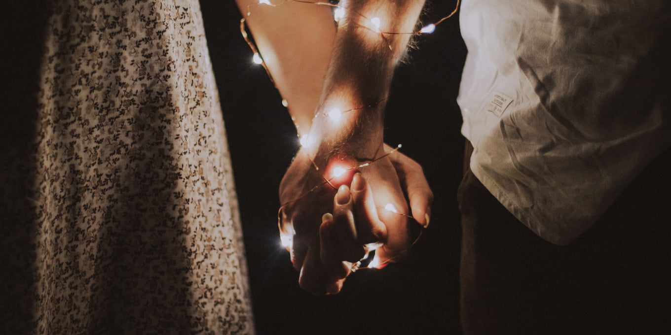 Couple holding hands with some led lights